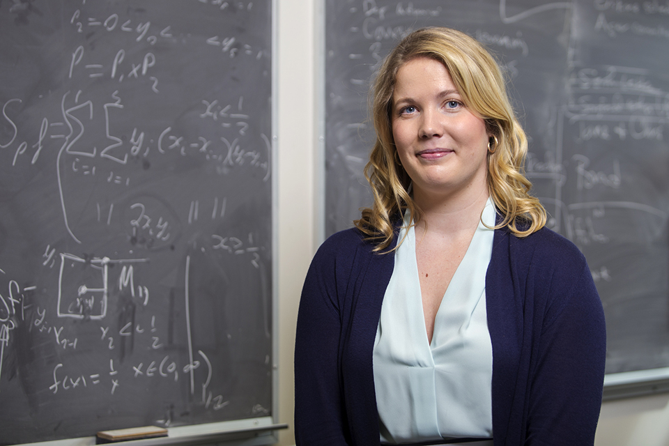Halverson-Duncan in front of a classroom chalkboard