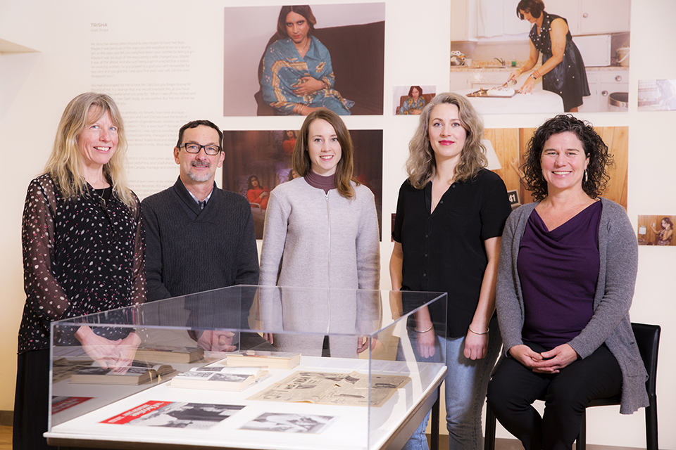 Members of Legacy Art Galleries standing by works of art in the gallery