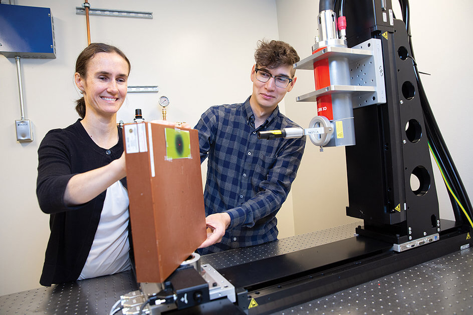 UVic medical physicist Magdalena Bazalova-Carter and graduate student Dylan Breitkreutz are researching how to reduce the cost of radiation therapy. Photo: Photo Services.