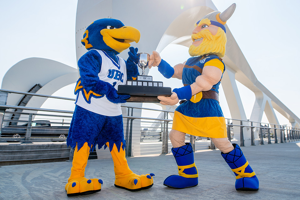 UBC Thunderbird and UVic Vikes mascots fight for the Legends Cup trophy