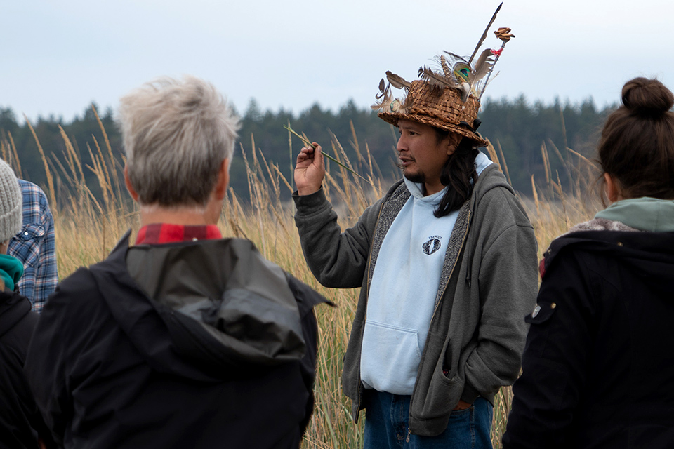 John-Bradley Williams, ethnobotanist and storyteller from the Tsawout First Nation, leads a class at TIXEN (Cordova Spit) as part of a UVic law field course in the re-emergence of WSÁNEĆ law