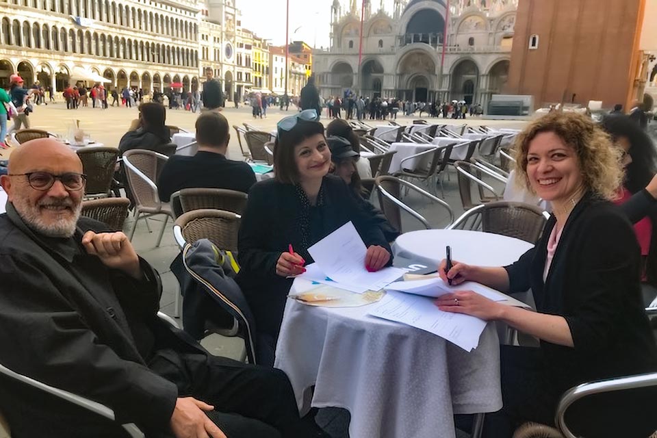 Three people sitting around a table