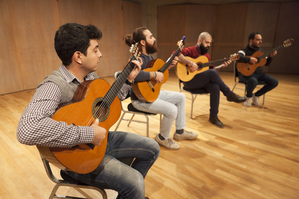 Quartet on stage playing music.