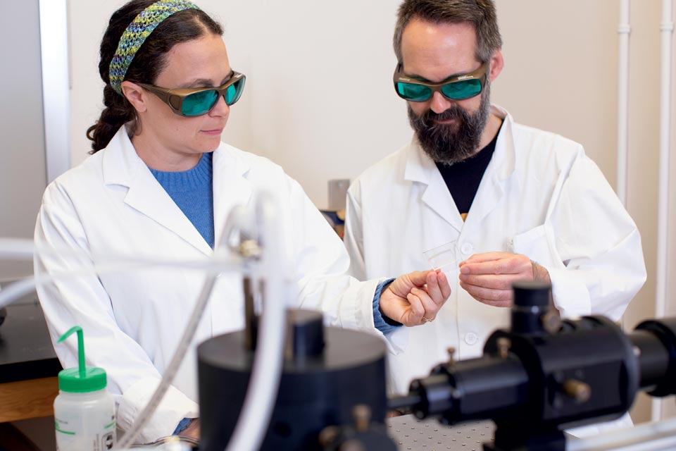 PhD student Liza Silverman and professor Matthew Moffitt pictured working in their UVic lab.