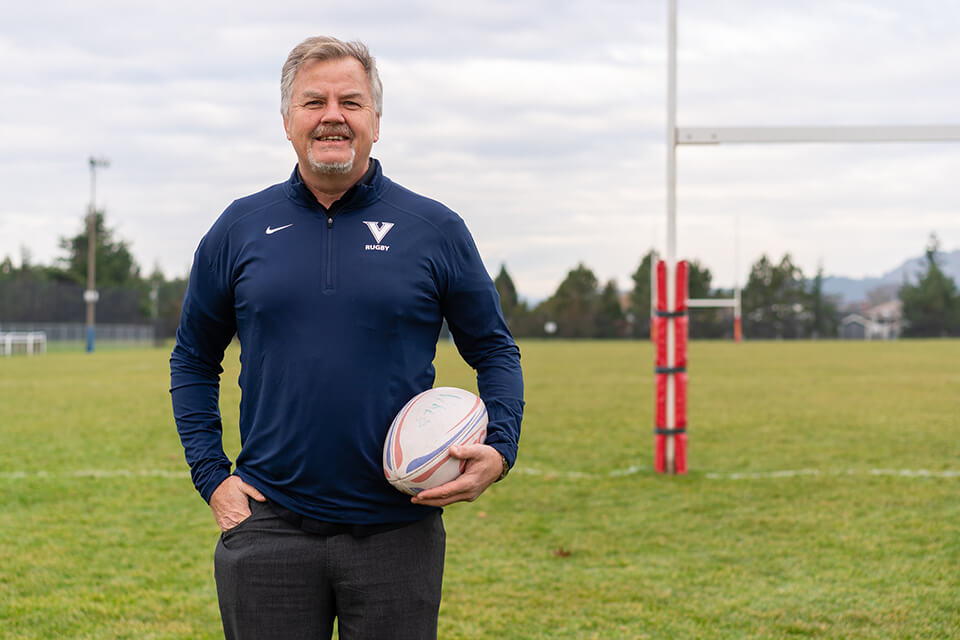 UVic Vike Michael Holmes holding a rugby ball