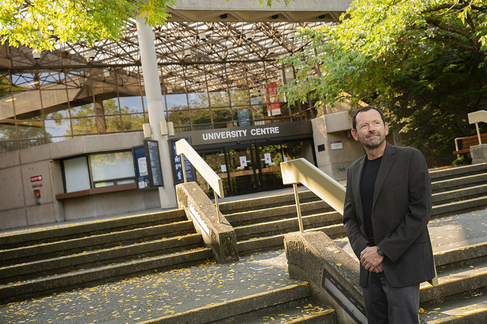 Jamie stands in front of the Jamie Cassels Centre