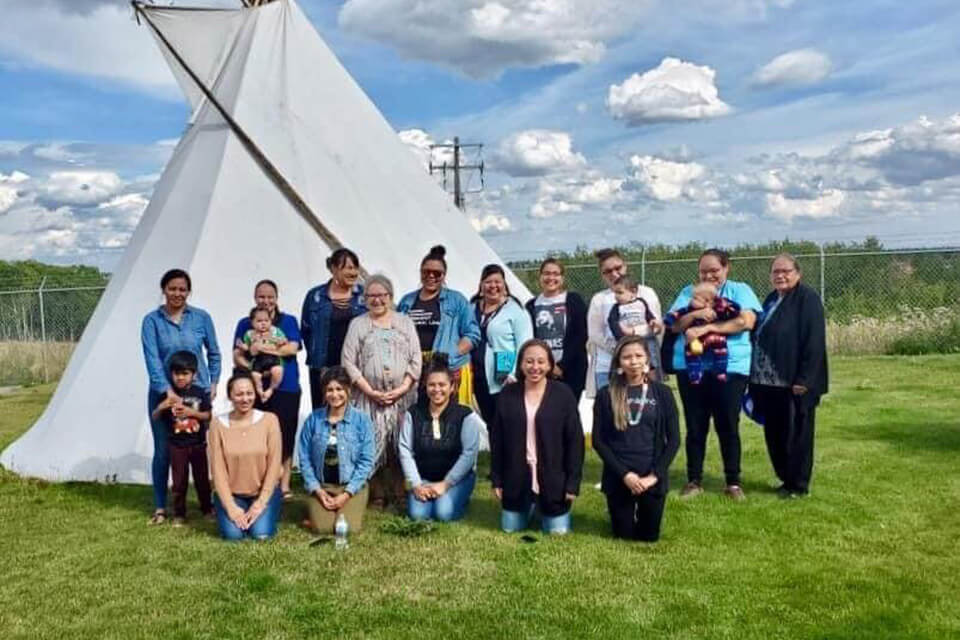 Participants in the Certificate in Indigenous Language Revitalization from the Tsuut'ina Gunaha Institute posing with community members, before the pandemic moved courses online.