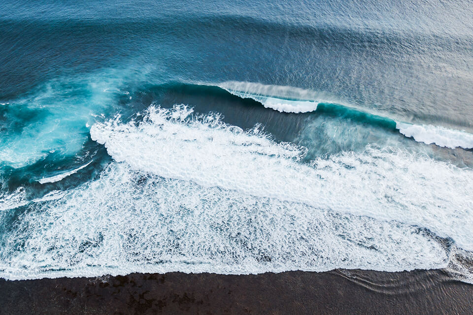 aerial shot of rolling blue ocean waves