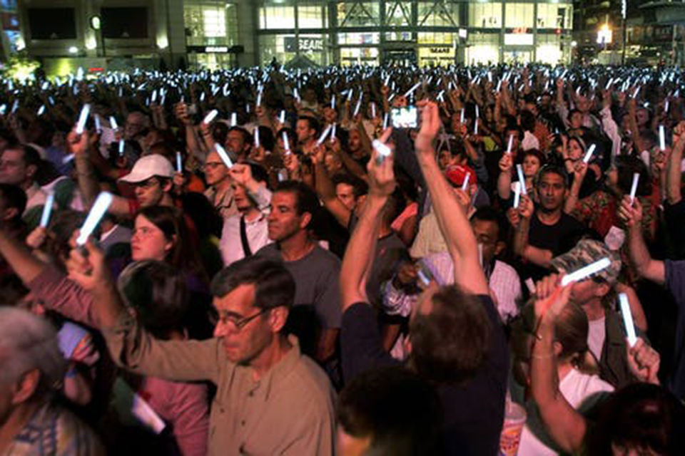 Thousands gather in a city square in downtown Toronto on Aug. 17, 2006 for a candlelight vigil to remember those who have died from AIDS. Credit: CP PHOTO/Nathan Denette