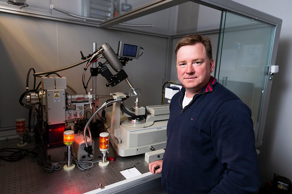 Alisdair Boraston stands in the lab