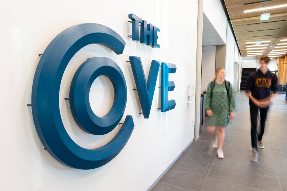 Two students walking outside the Cove dining hall.