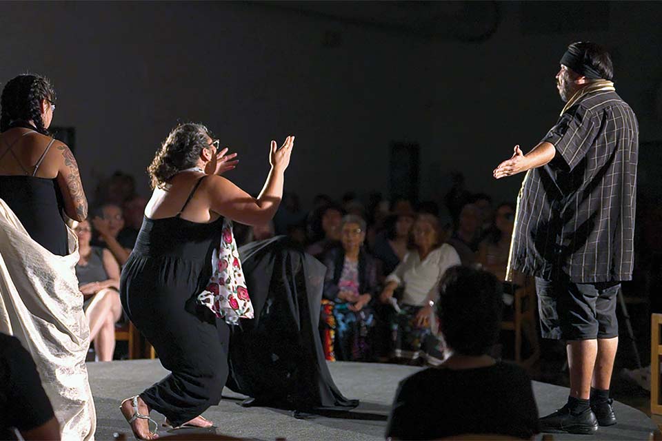 The cast of Jealous Moon performs onstage.
