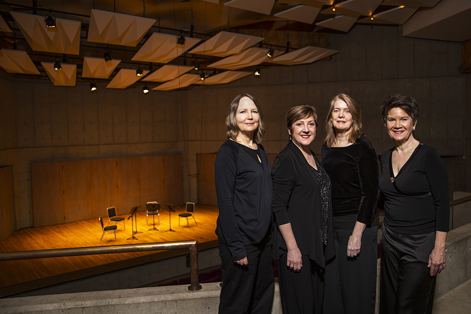 All four members of the all-female Lafayette string quartet stand above the Farquhar stage on the balcony, facing the camera with their empty seats on the stage - 19 months before taking their final bow.