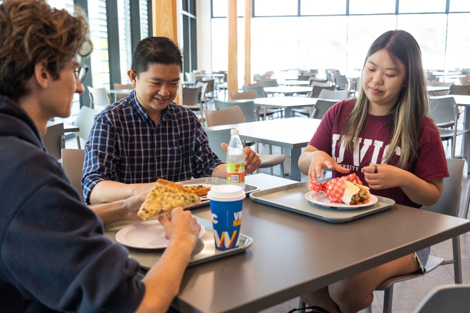 Three students dining on campus 