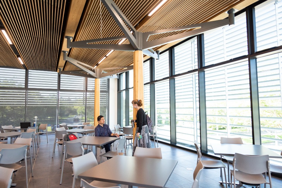 Two students in new dining facility was build with sustainability principles.