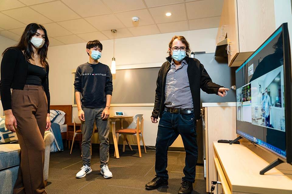 Three med students look at digital screen