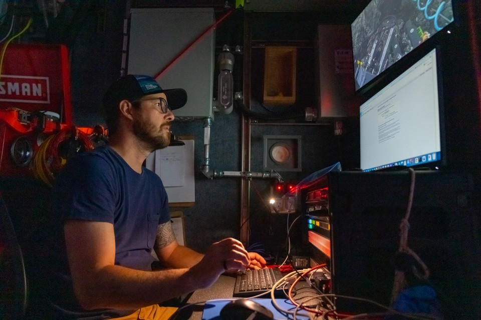 Co-author & ONC Senior Scientist, Fabio De Leo looking at a remote operated vehicle's video in the control room of a research vessel.