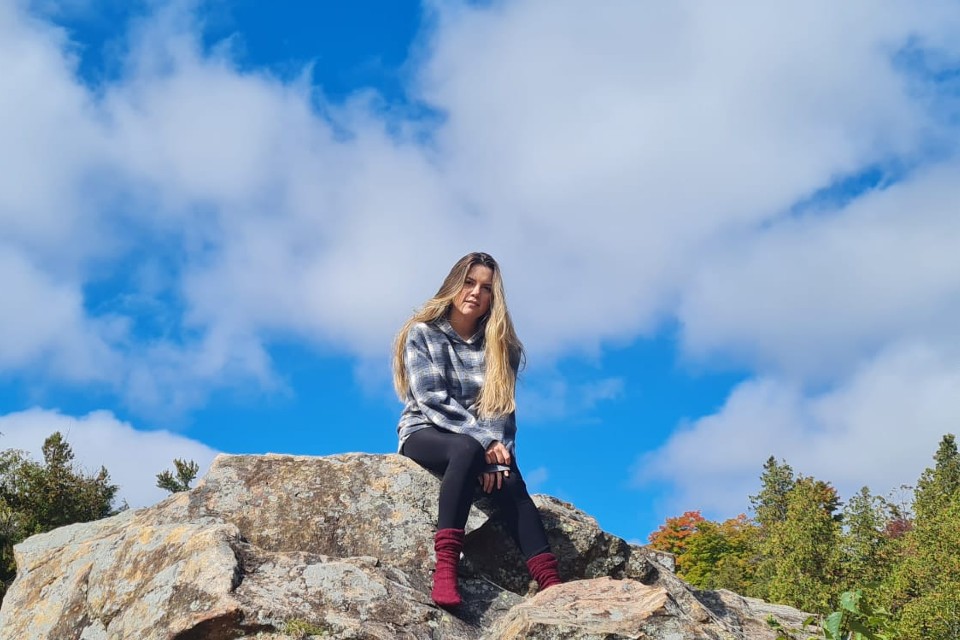 Gabrielle sitting from the hill