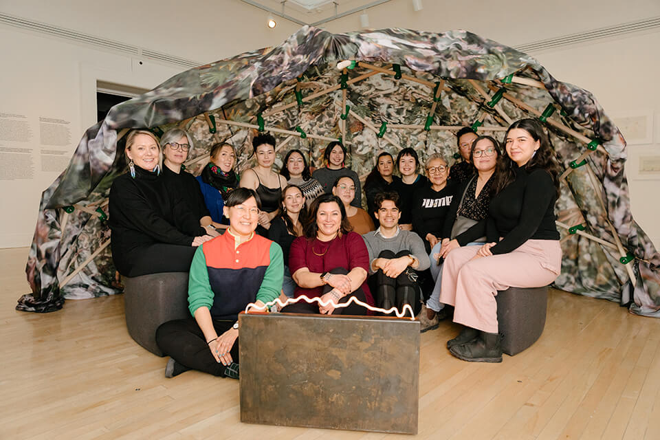 Heather Igloliorte, center, with students and faculty during the 2022 Inuit Futures curatorial institute, visiting the Inuit and Sami-led exhibition ᐊᖏᕐᕋᒧᑦ / Ruovttu Guvlui / Towards Home, December 3 2022. Photo by Julien Cadena