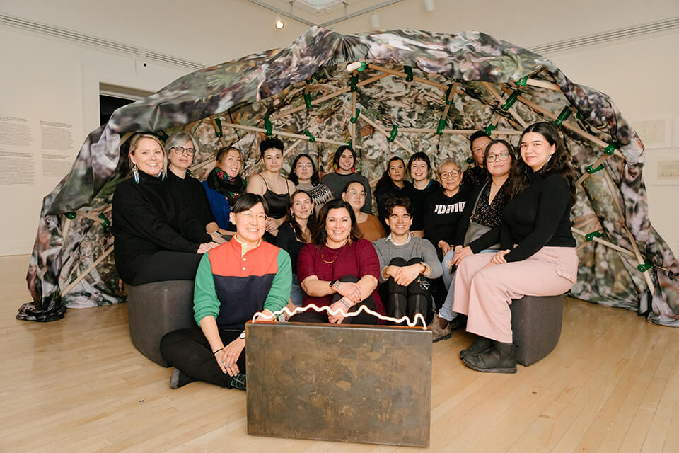 Heather Igloliorte, center, with students and faculty during the 2022 Inuit Futures curatorial institute, visiting the Inuit and Sami-led exhibition ᐊᖏᕐᕋᒧᑦ / Ruovttu Guvlui / Towards Home, December 3 2022. Photo by Julien Cadena