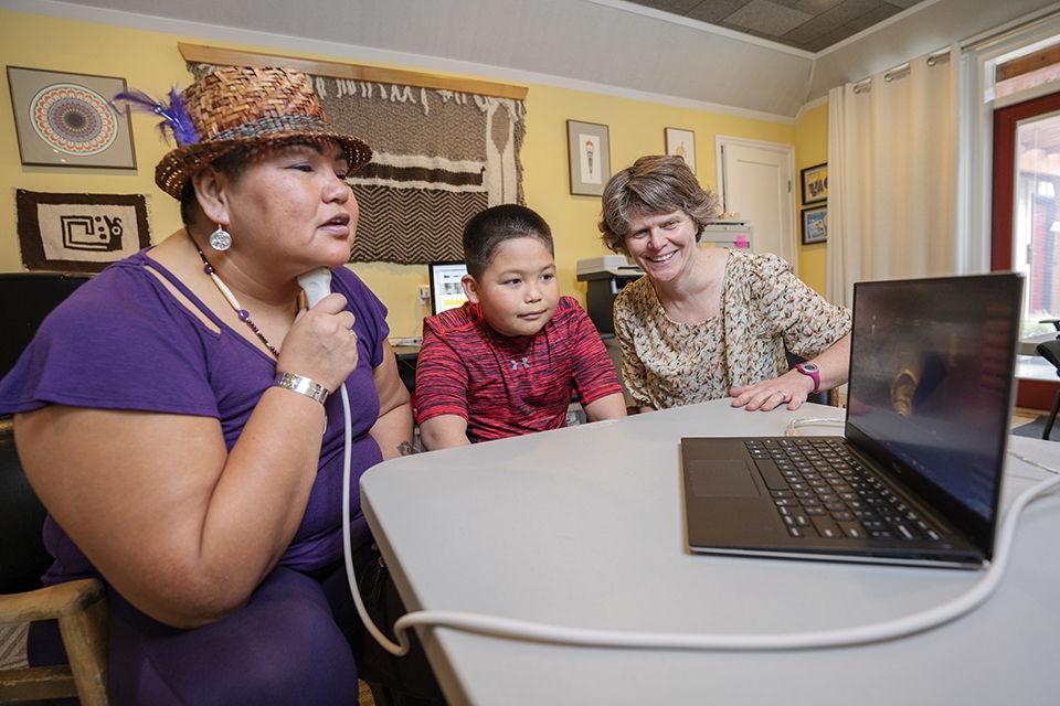 Agnes Violet Sharon Seymour practices her pronunciation using ultrasound technology with her son, Luke, and UVic linguist Sonya Bird.