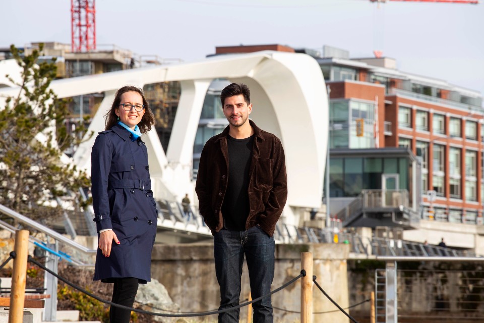 UVic climate policy expert Katya Rhodes stands with PhD student Aaron Hoyle in downtown Victoria. They are researching multiple ways that Canada can hit its climate targets while winning public support.