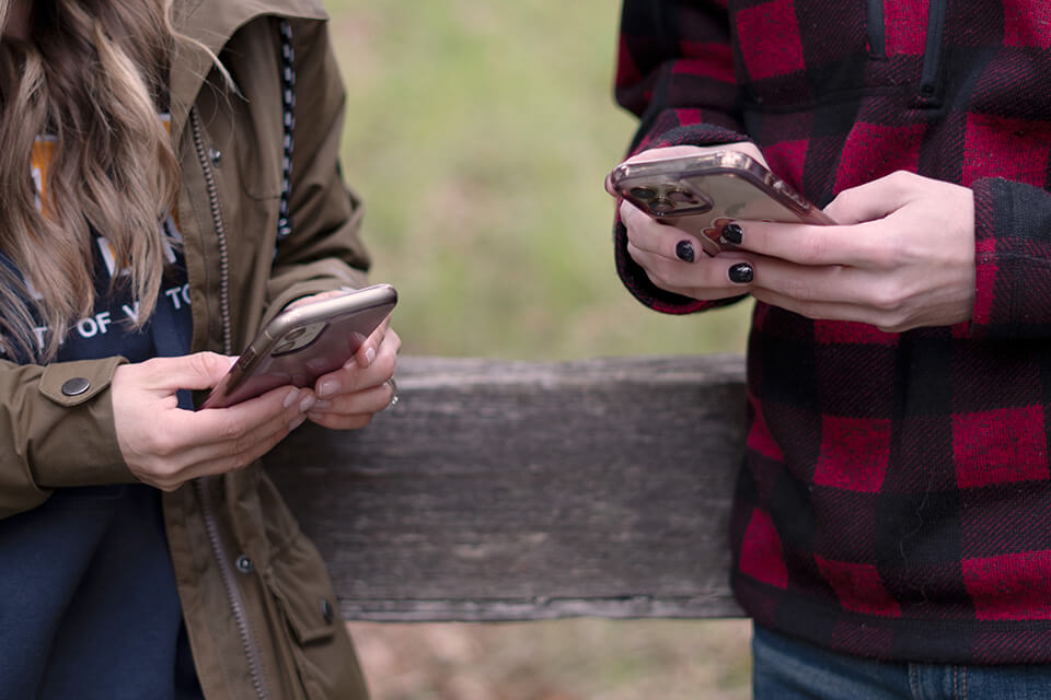 close up of hands holding mobile phones