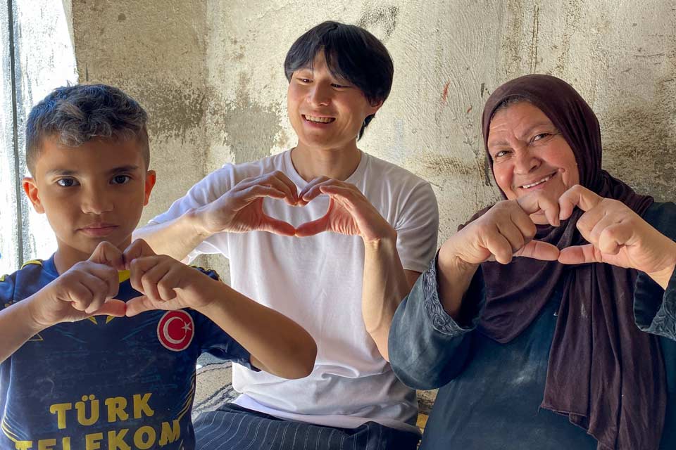 Co-director and cinematographer Guochen Wang flanked by Azzam and her grandson Majd.