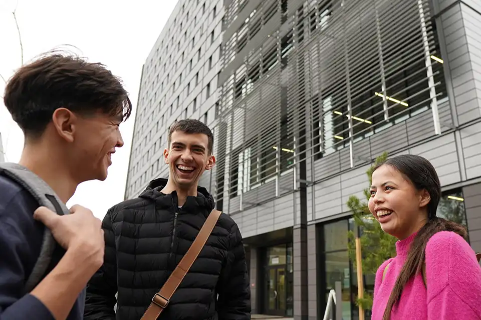 Ryder shares a laugh with co-residents of the Indigenous Living Learning Community, Ariel (left) and Tiffany (right) outside of Sŋéqə ʔéʔləŋ (Sngequ House).