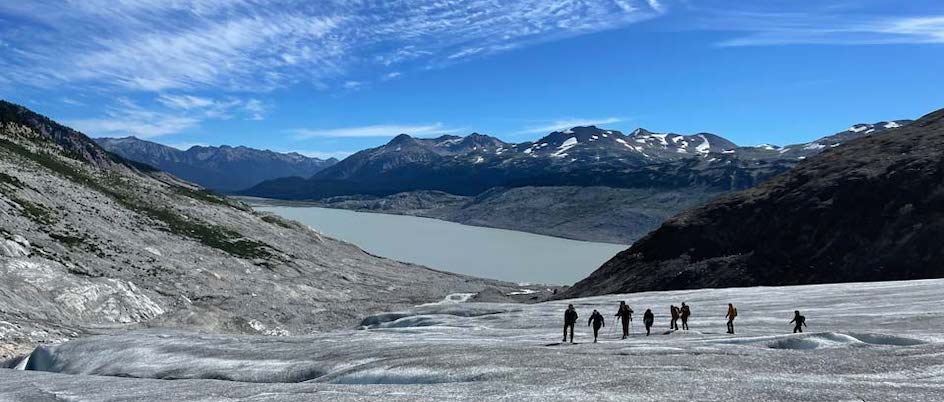 Students walk across a glacier landscape