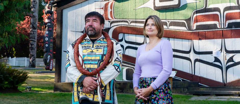 Two people standing on the traditional territory of the lək̓ʷəŋən peoples and of the Songhees and Esquimalt Nations.