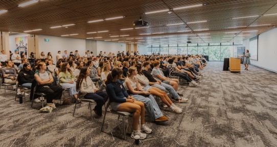 Students sitting together in a faculty welcome session.