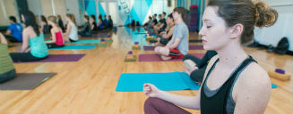 Student doing yoga in a studio