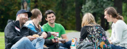 4 students hanging out on the quad