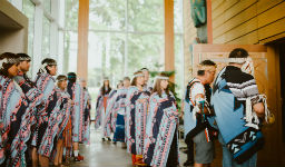 Participants entering the Ceremonial Hall for an Indigenous ceremony