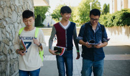 Three students walking on campus