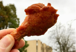 Chicken wing held up against the sky