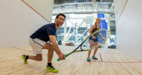 Two students playing squash