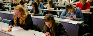 Students writing a test in a classroom setting