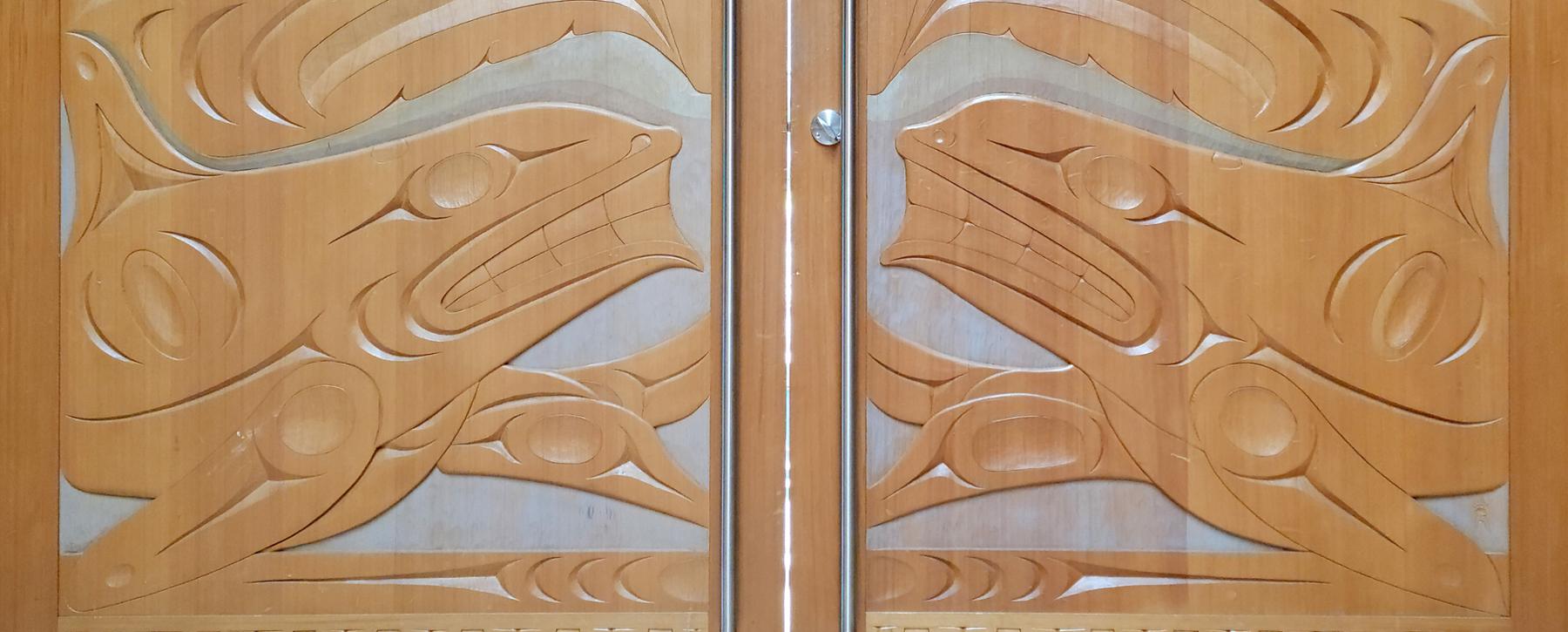Art on doors to hall in First People House