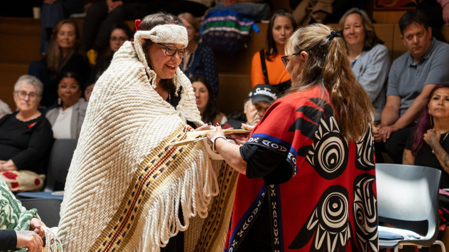 Lalita gifting Angela a beaded eagle feather
