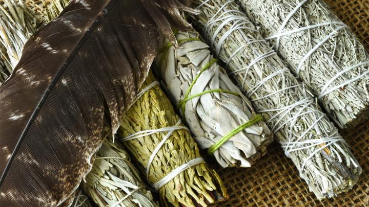 feather with smudging sticks