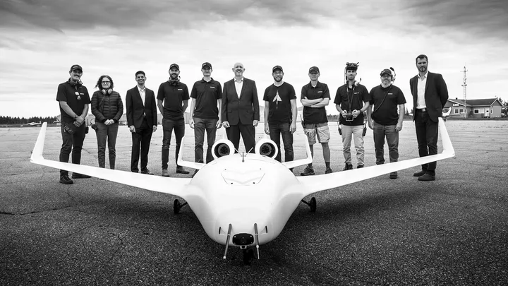 CfAR and Bombardier teams standing behind an aircraft models.