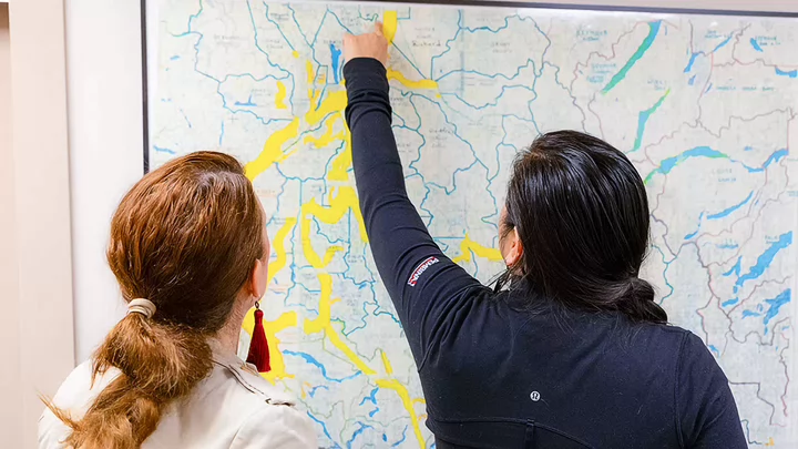 Two people analyzing a topographic map
