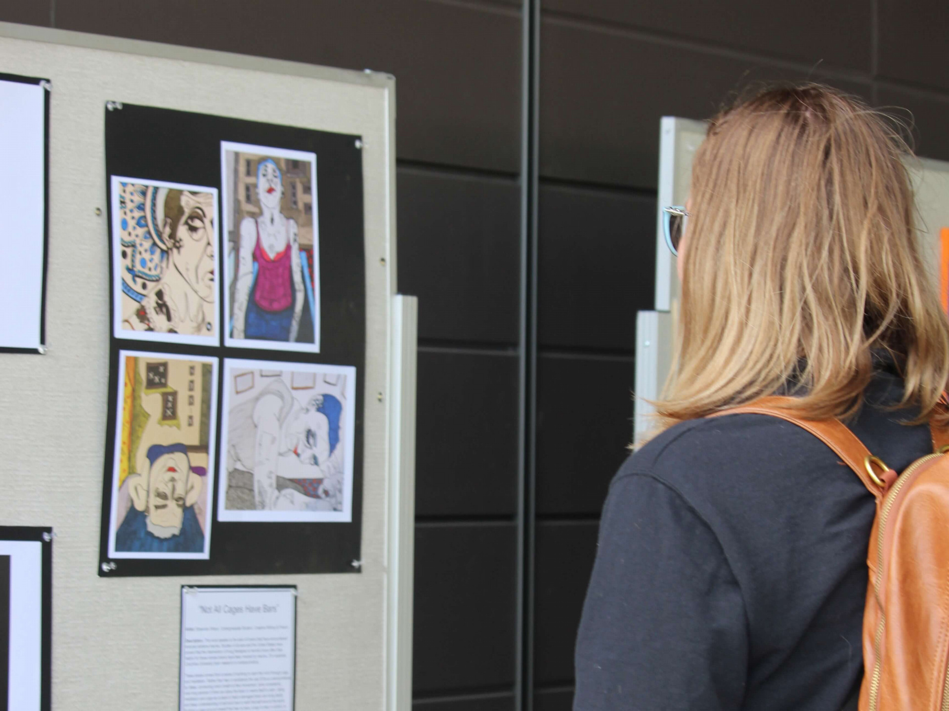 Student admires art at the Brain Art Contest 2024 Exhibition.