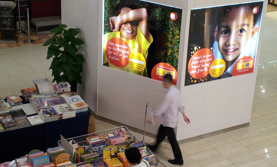 "Stay connected for less" - as a testament to the transnational nature of many Filipino families, mall signs in Singapore advertise phone and digital services for connecting with family back home.