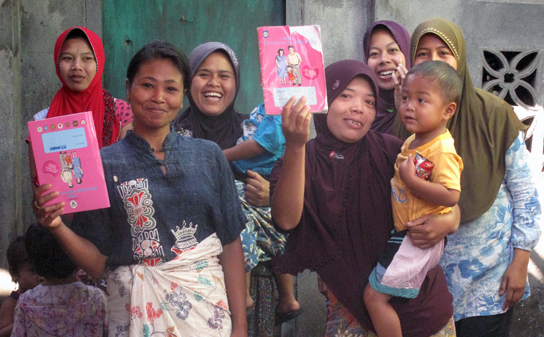 women holding their records of birth and immunization at a local maternal and child health centre in Lombok