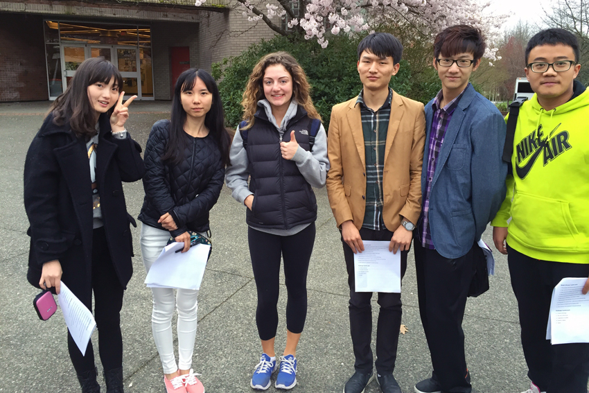 IYLP participants posing with a UVic student on campus as part of a scavenger hunt