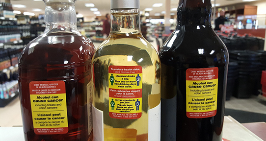 a photo of warning labels on bottles of alcohol
