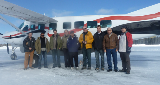 Researchers in front of a plane
